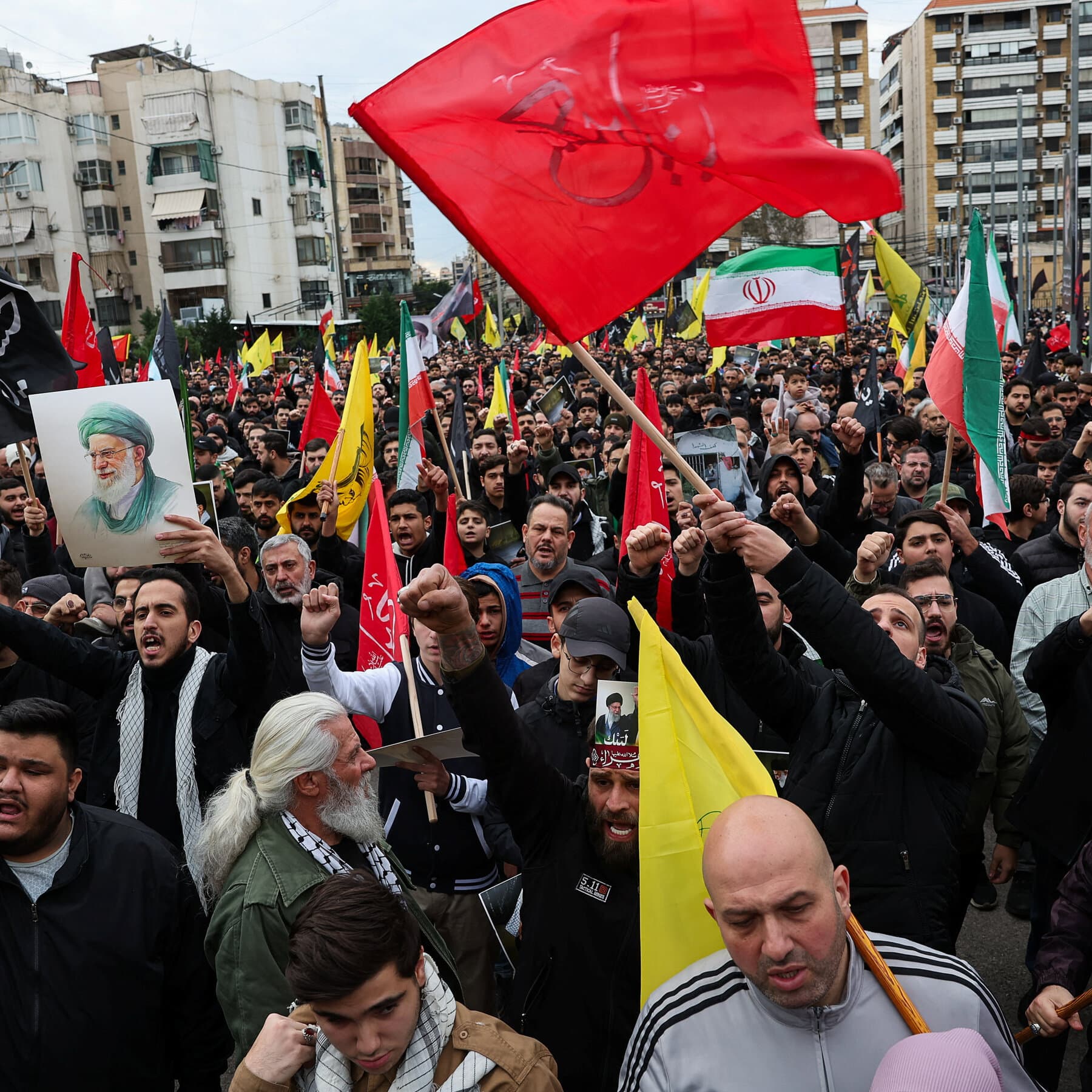 A gritty, high-contrast comic book style illustration. A large, menacing puppet master's hand reaches down from dark clouds at the top. The hand holds tangled, fraying strings attached to a crumbling city skyline that resembles Beirut. The city is in shades of grey and black, with stark red explosions. In the foreground, a small, scared dog sits amidst the rubble, looking at the viewer. The mood is hopeless and chaotic.