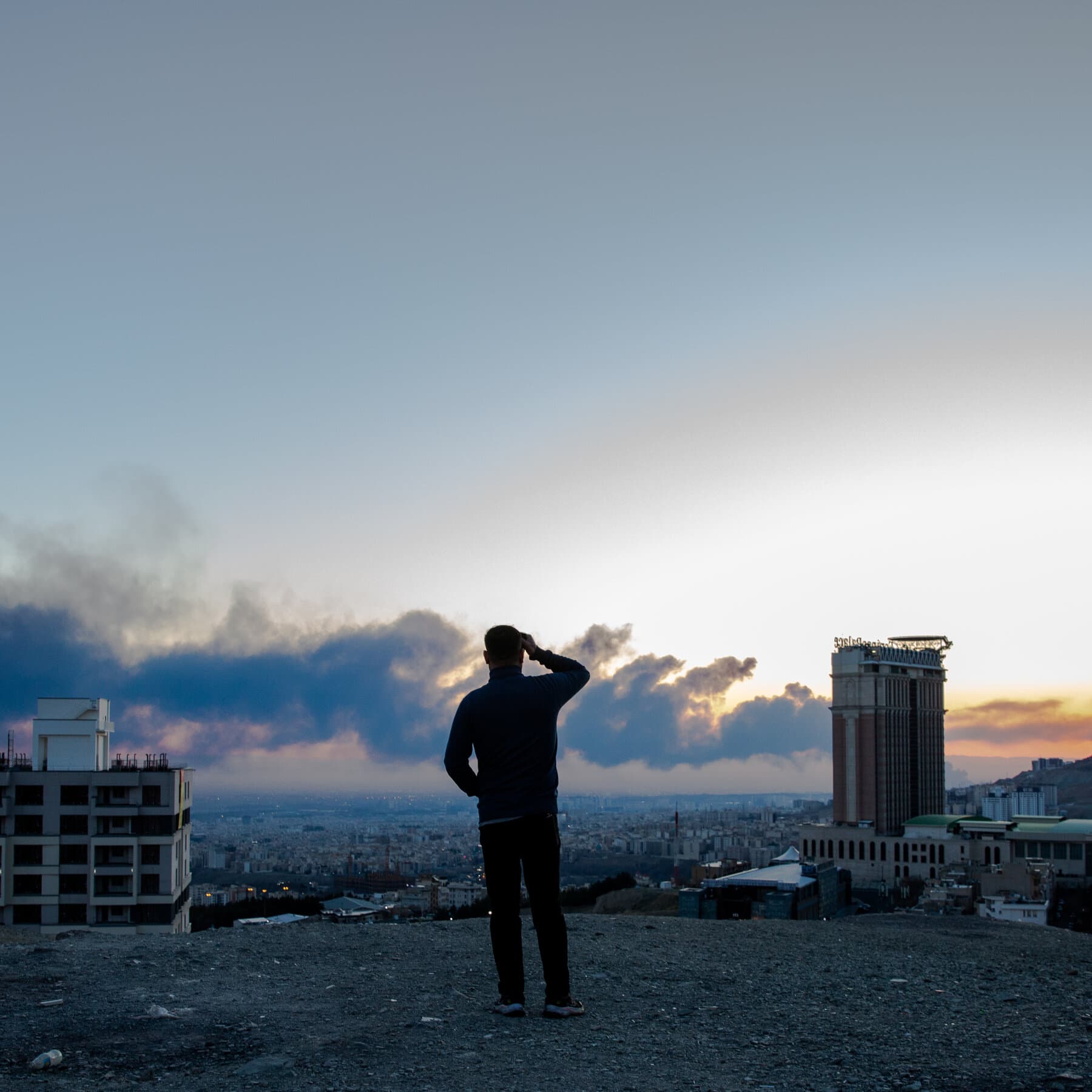 A gritty, cynical collage style illustration showing a stock market line graph crashing downwards in bright red, overlaid with a silhouette of a man in a suit gesturing wildly, oil barrels spilling black sludge, and a map of the Middle East with smoke rising, dark moody lighting, high contrast.