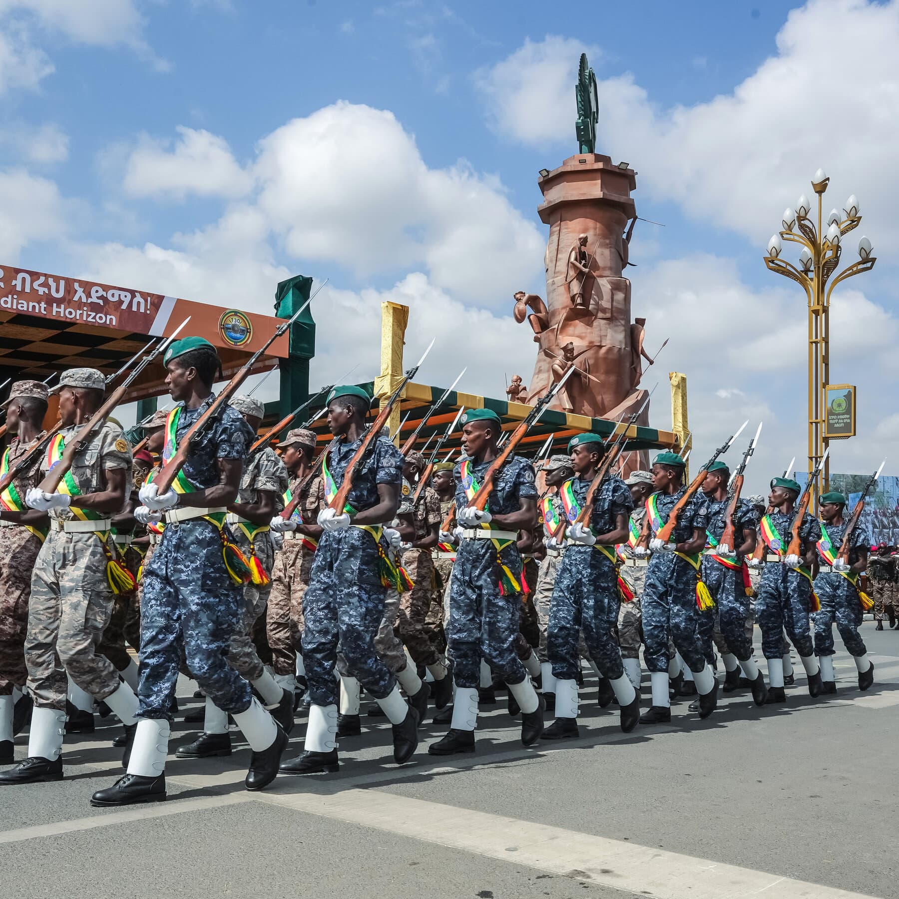 A rusty Nobel Peace Prize medal lying in the mud, half-buried, with a soldier's boot stepping near it, gritty, realistic style, cynical tone.