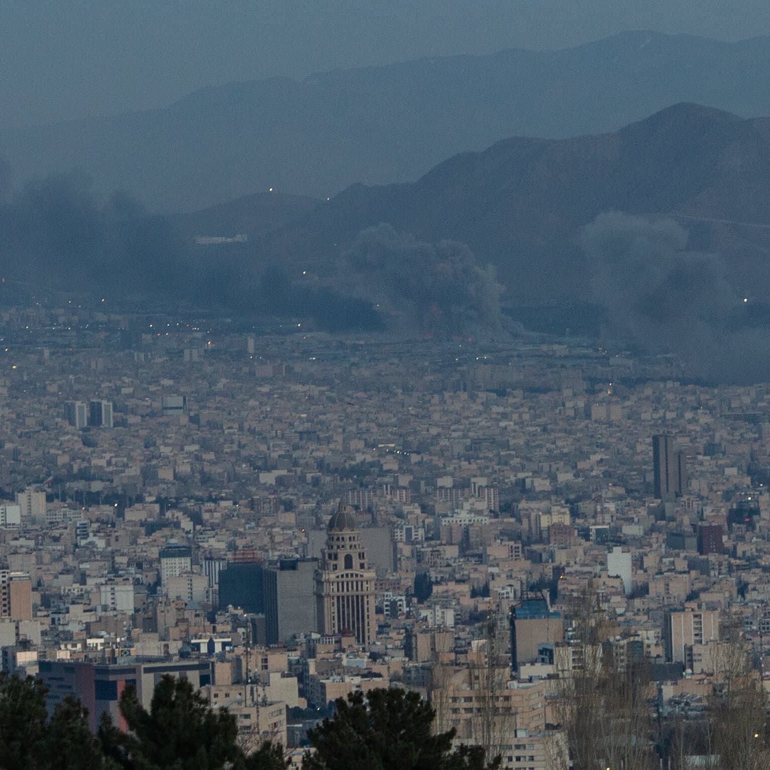 A gritty, high-contrast illustration of a missile exploding in a dark sky above a generic city skyline. In the foreground, silhouettes of men in suits stand watching calmly with their backs to the viewer. The style should be dark, cynical, and moody, resembling a noir graphic novel.