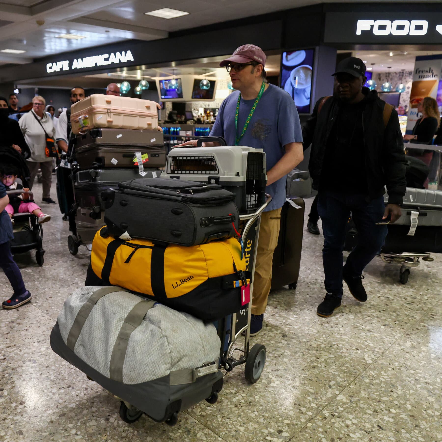 A conceptual editorial illustration showing a red emergency telephone hanging off the hook in an empty, dusty office, with a view of a chaotic, smoky city skyline through the window. The style should be moody, cynical, and slightly surreal, using muted blues and greys with splashes of urgent red.