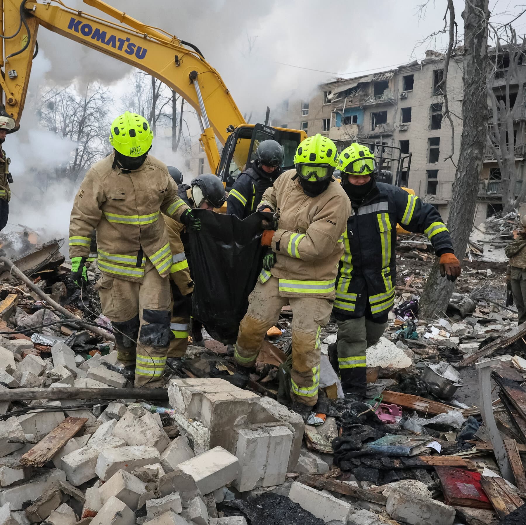 A gritty, high-contrast black and white illustration of a shattered five-story apartment building, with a single bright red child's balloon stuck in the grey rubble, style of a bleak political editorial cartoon.